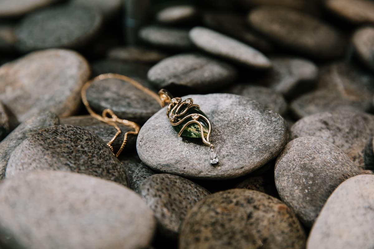 Contemporary Māori jewellery featuring New Zealand pounamu embraced by sculptural gold and diamonds, bringing precious stone, Māori-inspired form and fine jewellery craftsmanship together.