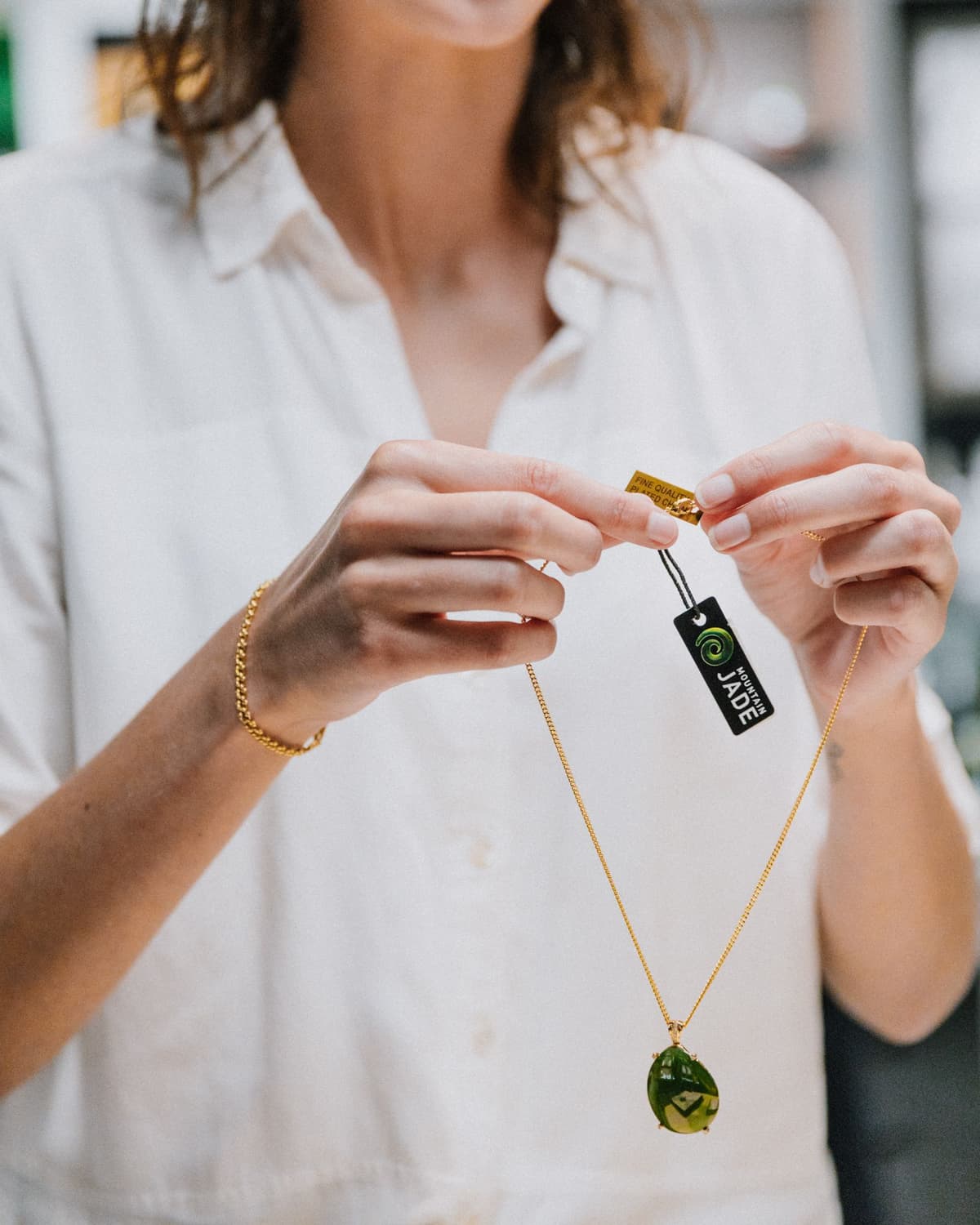 Authentic New Zealand pounamu set in gold as contemporary Māori jewellery, connecting the story and natural character of the stone with modern fine jewellery design.